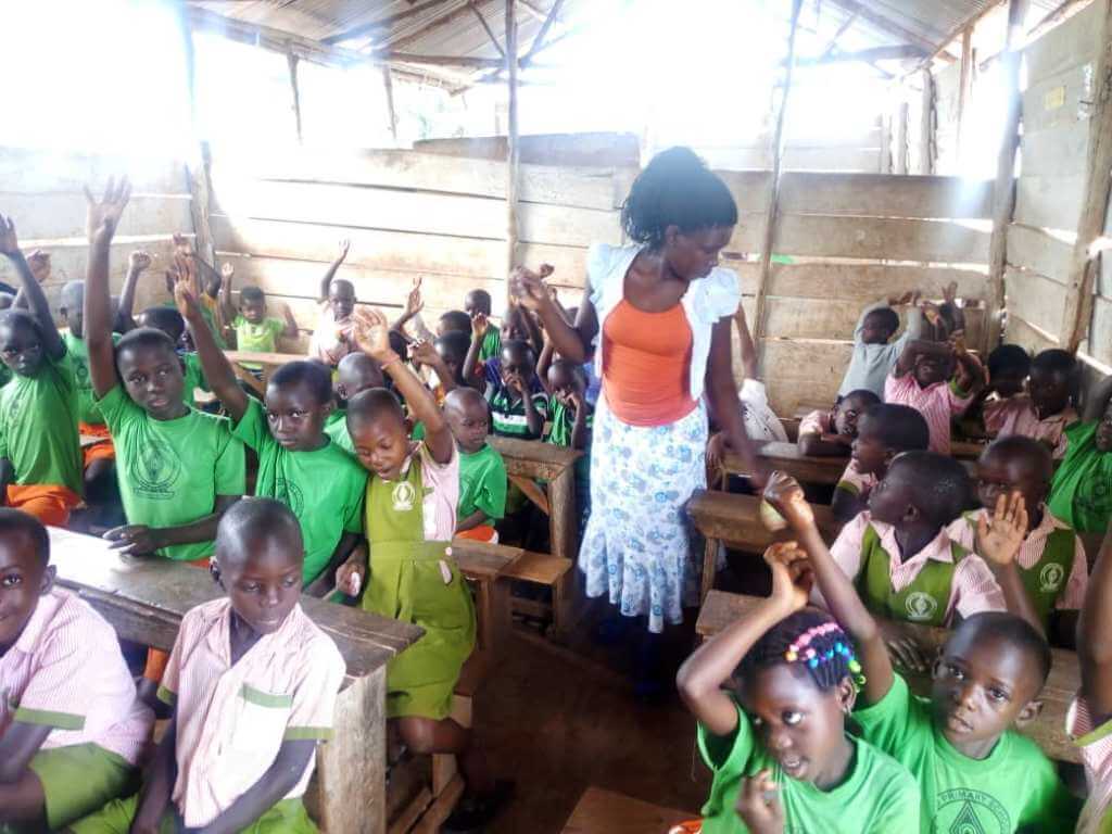 Students raising hands in class tini